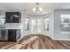 A sun-filled eat-in kitchen with wood floors, white double doors, and two window bays with views of the outdoor at 7115 N Lyndhurst Xing, McCordsville, IN 46055
