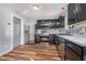 Modern kitchen with stainless steel appliances, dark cabinets, and a stylish tile backsplash at 7115 N Lyndhurst Xing, McCordsville, IN 46055