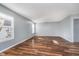 Inviting living room with laminate floors, neutral paint, and bright window at 7115 N Lyndhurst Xing, McCordsville, IN 46055