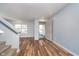 Bright living room with hardwood floors, staircase, and open front door at 7115 N Lyndhurst Xing, McCordsville, IN 46055