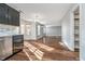 An open-concept living area with hardwood floors, white walls, and a view of the outdoor from the window at 7115 N Lyndhurst Xing, McCordsville, IN 46055