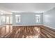 Open-concept living room featuring laminate floors and lots of natural light at 7115 N Lyndhurst Xing, McCordsville, IN 46055