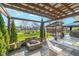 This patio features a pergola, fire pit, and manicured greenery, creating an inviting outdoor retreat at 7115 N Lyndhurst Xing, McCordsville, IN 46055