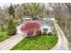 Aerial view of a single-story home with a well-manicured lawn, mature trees, and a driveway at 7145 Lafayette Rd, Indianapolis, IN 46278