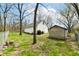 Spacious backyard with mature trees, a storage shed, and chainlink fence at 7145 Lafayette Rd, Indianapolis, IN 46278