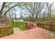 Charming backyard featuring a weathered deck, a manicured lawn, and mature trees at 7145 Lafayette Rd, Indianapolis, IN 46278