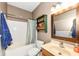 This well-lit bathroom is furnished with a bathtub and a wooden-framed mirror at 7145 Lafayette Rd, Indianapolis, IN 46278