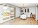 Dining room featuring hardwood floors, neutral walls, a chandelier, and access to a patio at 7145 Lafayette Rd, Indianapolis, IN 46278