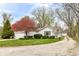 Charming home exterior with attached garage, driveway, and mature landscaping at 7145 Lafayette Rd, Indianapolis, IN 46278
