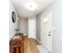 Welcoming hallway with wood-look flooring, neutral paint, and a decorative accent table at 7145 Lafayette Rd, Indianapolis, IN 46278