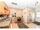 The functional kitchen shows wood cabinets and an adjacent laundry area at 7145 Lafayette Rd, Indianapolis, IN 46278