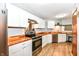 Modern kitchen with stainless steel appliances, butcher block countertops, and white cabinetry at 7145 Lafayette Rd, Indianapolis, IN 46278