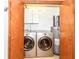 Convenient laundry room with modern washer and dryer units, storage cabinets and water heater at 7145 Lafayette Rd, Indianapolis, IN 46278