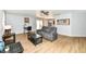 Open living room with hardwood floors, neutral walls, a ceiling fan, and a gray sofa at 7145 Lafayette Rd, Indianapolis, IN 46278