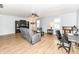 Bright living room with hardwood floors, neutral walls, ceiling fan, comfortable gray sofa, and a desk at 7145 Lafayette Rd, Indianapolis, IN 46278