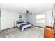 Spacious bedroom with ceiling fan, carpet flooring and a large window providing natural light at 7145 Lafayette Rd, Indianapolis, IN 46278