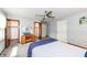Bedroom featuring neutral carpet, ceiling fan, and a decorative vanity area with storage at 7145 Lafayette Rd, Indianapolis, IN 46278