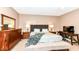 The comfortable main bedroom features two bedside tables and a desk, all bathed in natural light at 7145 Lafayette Rd, Indianapolis, IN 46278