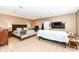 A sprawling main bedroom offers a seating area and large bed, with stylish tile flooring at 7145 Lafayette Rd, Indianapolis, IN 46278
