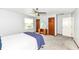 Comfortable bedroom showcasing carpet flooring, a ceiling fan, and ample closet space at 7145 Lafayette Rd, Indianapolis, IN 46278