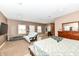 Spacious main bedroom with neutral tones, carpeted area, and a large bed with an ensuite kitchen at 7145 Lafayette Rd, Indianapolis, IN 46278
