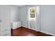 Cozy bedroom with hardwood floors and a bright window with views of the neighborhood at 715 Pioneer Dr, Indianapolis, IN 46217