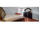 This bedroom features hardwood floors, neutral walls, and a dark wooden dresser with ornate mirror at 715 Pioneer Dr, Indianapolis, IN 46217