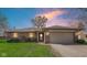 Charming single-story brick home featuring a two-car garage and well-maintained front lawn at 715 Pioneer Dr, Indianapolis, IN 46217