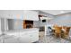 Bright kitchen featuring white cabinets, stainless steel appliances, and a dining area with a view to the living room at 715 Pioneer Dr, Indianapolis, IN 46217