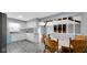 A well-lit kitchen with white cabinets, modern appliances, and a dining area; showcasing a functional design at 715 Pioneer Dr, Indianapolis, IN 46217