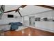 Open-concept living room with a brick fireplace, seamlessly connected to the modern kitchen and dining area at 715 Pioneer Dr, Indianapolis, IN 46217