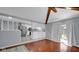 A living room with a smooth hardwood floor view showcasing an open kitchen design and stainless steel refrigerator at 715 Pioneer Dr, Indianapolis, IN 46217