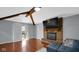 Warm living room featuring a cozy brick fireplace and sliding glass doors leading to the backyard at 715 Pioneer Dr, Indianapolis, IN 46217