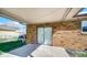 Covered patio with brick walls, a sliding glass door, and a concrete floor at 715 Pioneer Dr, Indianapolis, IN 46217