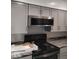 Modern kitchen featuring gray cabinetry, countertops, and stainless steel appliances at 721 1St Ne Ave, Carmel, IN 46032