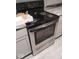 Close up view of a new stainless steel Frigidaire oven and gray cabinetry at 721 1St Ne Ave, Carmel, IN 46032