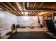Unfinished basement space with exposed ceiling joists, white wrapped walls and fitness equipment at 729 Stonehenge Way, Brownsburg, IN 46112