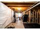 Unfinished basement with exposed ceiling, wrapped walls and fitness equipment and work out area at 729 Stonehenge Way, Brownsburg, IN 46112