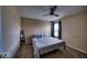Neutral bedroom with a queen bed, ceiling fan, carpet flooring and a window with curtain and shade at 729 Stonehenge Way, Brownsburg, IN 46112