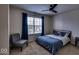 Cozy bedroom features a bed with a patterned comforter, a chair and a window with blue curtains at 729 Stonehenge Way, Brownsburg, IN 46112