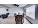 Formal dining room features a wooden table with six chairs, a ceiling fan, and bright natural light from large windows at 729 Stonehenge Way, Brownsburg, IN 46112
