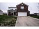 Charming two-story home with a brick facade and attached two-car garage, complemented by a well-maintained lawn at 729 Stonehenge Way, Brownsburg, IN 46112