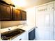 Convenient laundry room features updated appliances, upper cabinets for storage, and a white door at 729 Stonehenge Way, Brownsburg, IN 46112