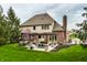 A backyard featuring an inviting outdoor lounge space, including a dining set and covered structure at 7326 Elm Ridge Dr, Indianapolis, IN 46236