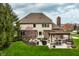 Secluded backyard with a well-appointed patio area, outdoor kitchen and beautifully landscaped yard at 7326 Elm Ridge Dr, Indianapolis, IN 46236