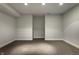 Unfinished basement space with neutral walls and carpet, offering potential for customization at 7326 Elm Ridge Dr, Indianapolis, IN 46236