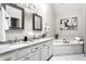 Bright bathroom boasts a double vanity, soaking tub, and elegant finishes and fixtures throughout at 7326 Elm Ridge Dr, Indianapolis, IN 46236