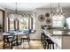 Bright eat-in kitchen features a marble table, modern chandelier, and built-in bench seating at 7326 Elm Ridge Dr, Indianapolis, IN 46236