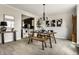 Open-concept dining room with modern chandelier and view into the stylish kitchen at 7326 Elm Ridge Dr, Indianapolis, IN 46236