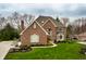 Beautiful brick two-story home with a manicured lawn and landscaping at 7326 Elm Ridge Dr, Indianapolis, IN 46236